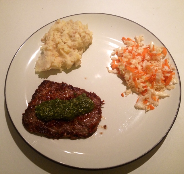 Parmesan crusted steak topped with pesto, celeriac and potato mash, and a carrot/cabbage salad